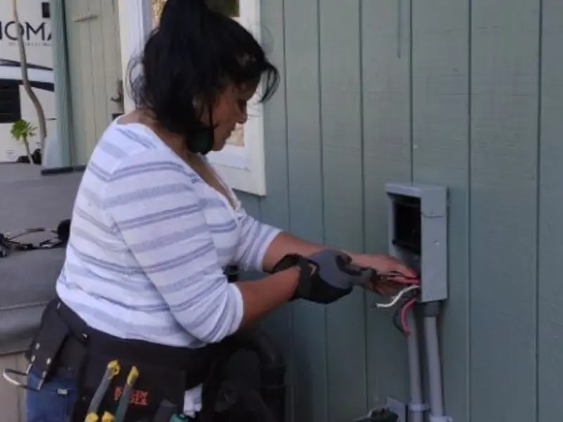 Licensed electrician wiring an exterior subpanel in Swannanoa