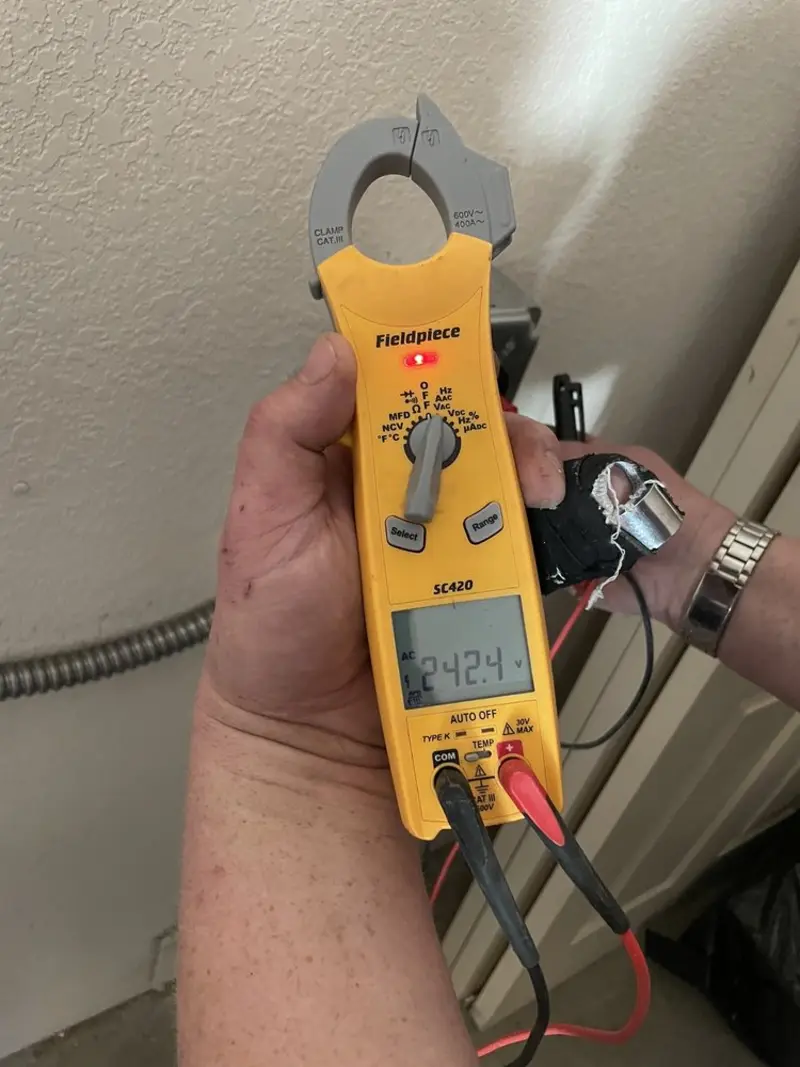 Voltage testing with clamp meter during Recessed Lighting Installation in Swannanoa